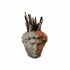 a sculpture of a man's head with arrows sticking out of it