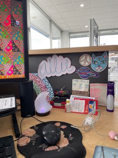 an office desk with a computer, mouse and other items on top of the desk