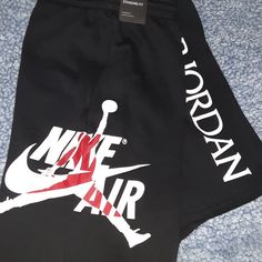 Tags Still On. Its Size: M. White Tank Top With Black Sweatpants Shorts. The Shirt Has Black And Red Print On It And The Shorts Have White And Red Print On It. Black Cotton Pants With Logo Print, Casual Black Pants With Logo Print, Nike Bottoms With Letter Print For Streetwear, Nike Streetwear Bottoms With Letter Print, Nike Casual Bottoms With Letter Print, Casual Nike Bottoms With Letter Print, Nike Black Bottoms With Letter Print, Air Jordan Outfit, Nike Air Jordans Outfit