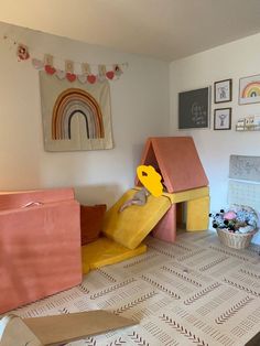 a child's playroom with toys and decor on the walls, including a yellow slide