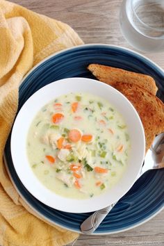 a bowl of soup with bread on the side