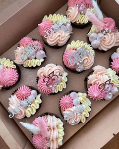 a box filled with lots of cupcakes covered in frosting