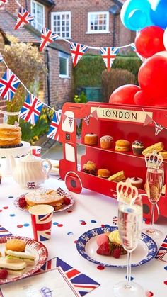 a table topped with cakes and cupcakes on top of red white and blue plates