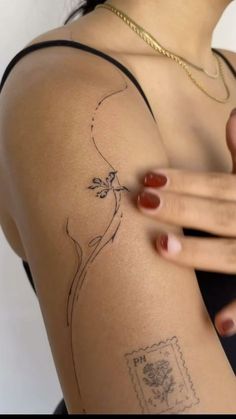 a woman's arm with a tattoo on the back of her shoulder and hand