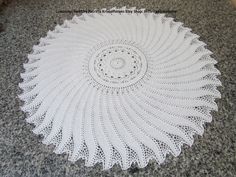 a crocheted doily is sitting on the floor