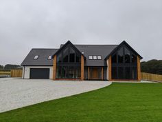 a large house sitting on top of a lush green field