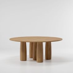 a round wooden table with four legs