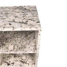 a white marble table with two shelves on each side