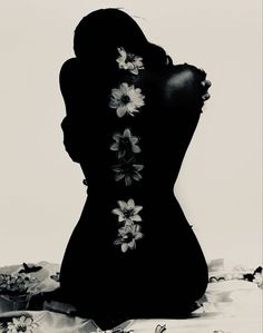 the back of a woman's body with flowers on it