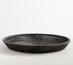 a black basket sitting on top of a white table