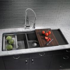 a kitchen sink that has some vegetables on the counter top and is next to it