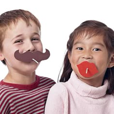 two children with fake mustaches on their mouths