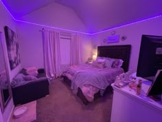 a bed room with a neatly made bed and purple lights on the wall above it