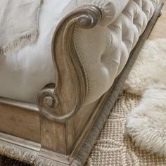 an antique style bed with white linens and pillows