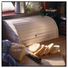 slices of bread on a cutting board next to a knife and some other food items