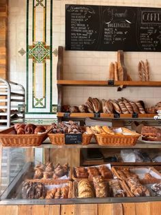 breads and pastries on display in a bakery