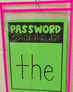 a green sign hanging on the side of a white brick wall that says,'the password of the day '