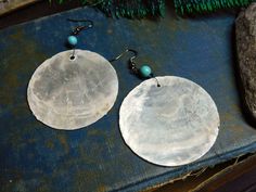 "I love love love the moon, and the sea, and the harbor, so when I found these amazing Capiz shells , I knew exactly how I'd be using them. I paired them with small round Turquoise beads. All the wiring & the French style hook is gunmetal. Each pair is made to order, so anticipate slight differences in your Capiz shell & turquoise stones. Total length is 3\" Enjoy! fyi Capiz shells are somewhat delicate, if you drop them, they will break." Bohemian Shell Earrings For Gift, Bohemian Shell-shaped Earrings For Gift, Bohemian Silver Shell Earrings, Handmade Round Shell Jewelry, Handmade Round Bohemian Shell, Turquoise Bead Earrings, Big Statement Earrings, Earrings Moon, Capiz Shell