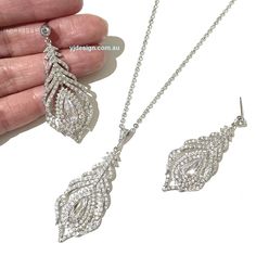 "A peacock wedding bridal jewelry set with earrings and necklace featuring peacock feather shape made of cubic zirconia.These cz jewelry come in tarnish resistant bright silver rhodium finish. Earrings are about 2\" (5cm) including cz-studded sterling silver posts. Pendant is about 2 1/8\" (5.3cm) with bail. Chain length can be added with a 2\" extender chain. View matching pieces or similar designs at https://etsy.me/2uxyfCu View more peacock accessories at https://etsy.me/KKSOE9 and https://et Peacock Accessories, Art Nouveau Wedding, Nouveau Wedding, Boho Wedding Earrings, Art Nouveau Weddings, Silver Bridal Earrings, Bridal Jewelry Set, Art Nouveau Jewelry, Wedding Bridal Jewellery