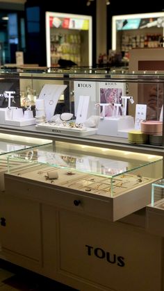 the inside of a store with jewelry on display