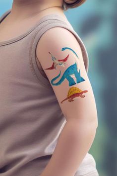 A tattoo bar is a super fun and creative party activity that kids will love!Set up a table with temporary tattoos featuring fun themes like dinosaurs, animals, or rainbows, along with some damp sponges or wipes for easy application.It’s a simple way to keep the kids entertained, and they’ll adore showing off their cool tattoos to everyone! See more party ideas and share yours at CatchMyParty.com Party Tattoos, Activities For Boys