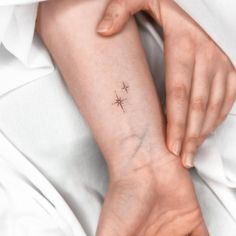 a person with a small star tattoo on their arm