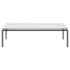 a glass table with metal legs on a white background