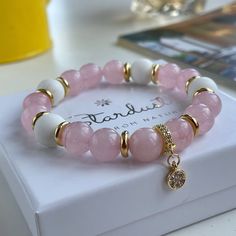 Luxury rose quartz and white coral bracelet matched with 14k gold plated separators and shimmering zircon charm. The bracelet is made from high quality materials and feels heavy. Could be the perfect gift for your girlfriend. 💖Wearing Rose Quartz jewelry: 💖 Rose quartz helps agains stress, relieves emotional stress, calmes down, makes your heart spread happiness and love. It removes the pain of old emotional and heart issues. Rose quartz enhances self-esteem and self-confidence, improves mutua Elegant White Rose Quartz Crystal Bracelet, White Rose Quartz Beaded Bracelets As Gift, White Rose Quartz Beaded Bracelet As Gift, White Rose Quartz Crystal Bracelet As A Gift, Feels Heavy, Rose Quartz Jewelry, Coral Bracelet, Quartz Jewelry, White Coral