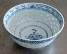 a blue and white bowl sitting on top of a table