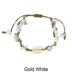 a bracelet with white beads and gold accents