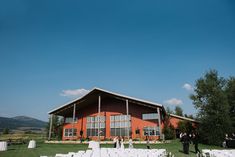 an outdoor wedding venue with white chairs