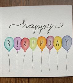 a happy birthday card with watercolor balloons and the words happy birthday written on it