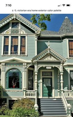 an old victorian style house with green paint and white trim on the front porch, stairs leading up to the second floor