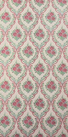 a pink and green flowered wallpaper with red flowers on it's side