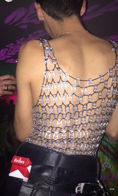 the back of a woman's top that has chains on it and is wearing black leather pants