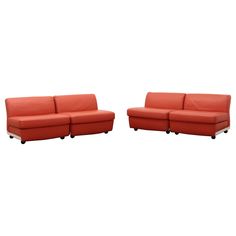 two red couches sitting next to each other