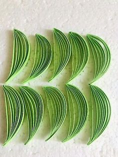 six pieces of green paper cut in half