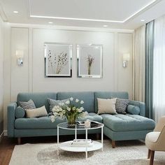 a living room with blue couches and white rugs on top of a wooden floor