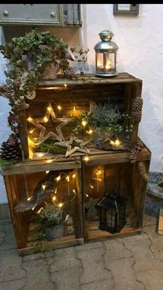 an old wooden cabinet is decorated with plants and lights