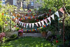 an outdoor area with flags and potted plants