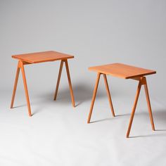 two small wooden tables sitting next to each other