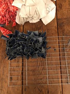 several pieces of clothing sitting on top of a metal rack next to a wooden floor