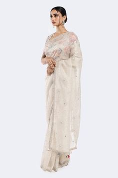 Off white saree with sequin scatter motifs. Comes with floral patterned sequined blouse. - Aza Fashions White Anarkali Blouse With Sheer Dupatta, White Blouse With Sheer Dupatta For Diwali, White Blouse For Eid Reception, White Blouse With Chikankari Embroidery For Reception, White Chikankari Embroidery Blouse For Reception, Festive White Tissue Silk Blouse, White Sequined Pre-draped Saree For Designer Wear, Festive White Pre-draped Saree With Sequins, White Pre-draped Saree With Mirror Work For Eid