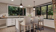 a kitchen with an island and bar stools next to the window overlooking the trees