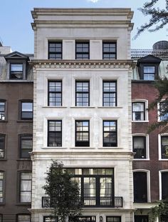 an apartment building with many windows and balconies on the front, in new york city