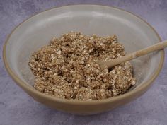 a bowl filled with oatmeal and a wooden spoon