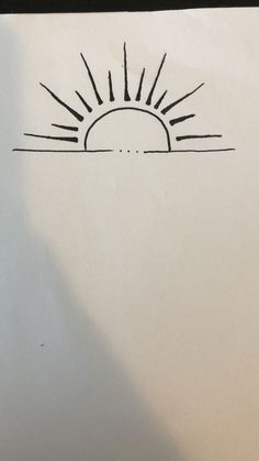 a drawing of the sun is shown in black ink on white paper with a pen