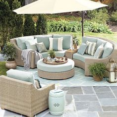 an outdoor patio with furniture and umbrella