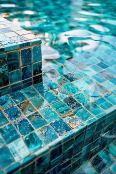 a pool with blue tiles on the side