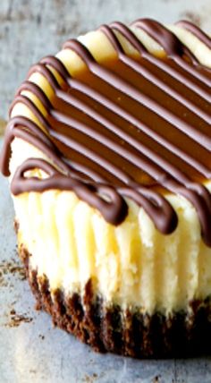 a chocolate and white cheesecake sitting on top of a counter